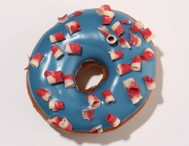 donut with red and white curls, dipped in a blue ganache