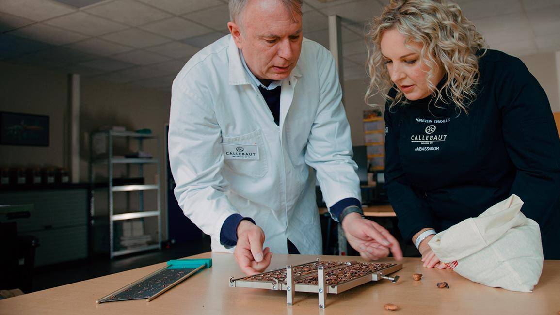 Kirsten Tibballs and Callebaut expert checking the quality of the callebaut cocoa beans