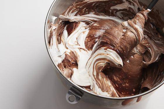 Cacao powder being folded into a batter